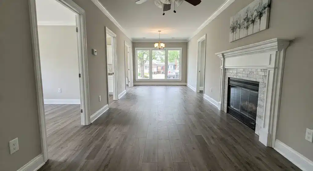 A spacious hallway with polished hardwood floors and a ceiling fan, enhancing the room's comfort and style.6502426 A spacious hallway with polished hardwood floors and a ceiling fan, enhancing the room's comfort and